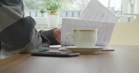 Young handsome man, student studying in his home, checking and reading notes.  Stock Footage 124103271