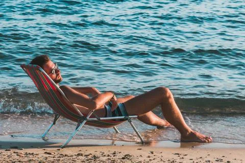 Young handsome man sunbathing Stock Photos