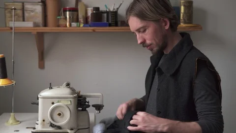 Young handsome man tailor smiling in sewing workshop Stock Footage 101369078