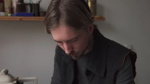 Young handsome man tailor working in leather workshop Stock Footage 101776885