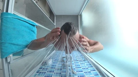 Young handsome man takes a shower Stock Footage 86256860