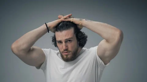 Young handsome man taking care of his hair. Stock Footage 127801853