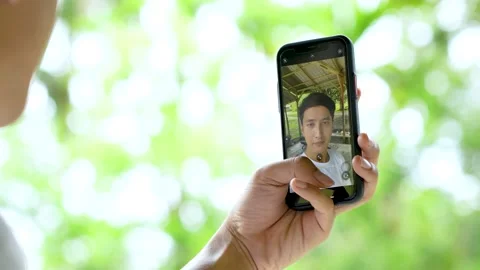 A Young Handsome Man Taking Multiple Selfie Below a Hut in the Nature Stock Footage 208925293
