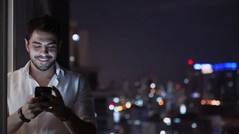 Young Handsome Man Texting and Sends Voice Message Phone Stock Footage 83730848