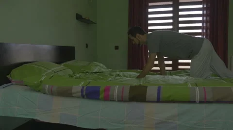 Young handsome man throwing himself in bed and sleeping Stock Footage 59841511