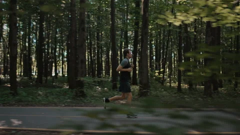 Young handsome man train for marathon run in park Stock Footage 168743865
