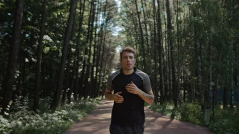 Young handsome man train for marathon run in park 動画素材 169663240