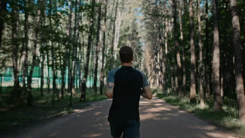 Young handsome man train for marathon run in park Stock Footage 169664159