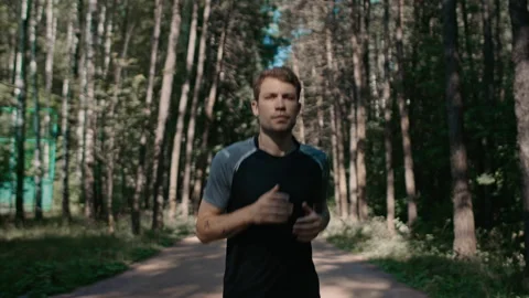Young handsome man train for marathon run in park Stock Footage 170642579