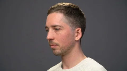 Young handsome man turning head to the camera Stock Footage 70486370