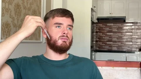 Young handsome man using beard growth product applying serum with dropper on Stock Footage 232112280