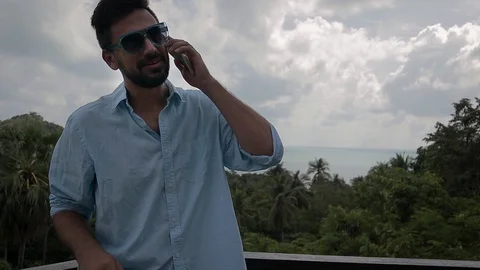 Young handsome man using his smartphone at the vacation. Stock Footage 100957406