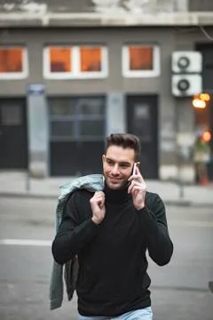Young handsome man using his cell phone, enjoying a day on the street Stock Photos