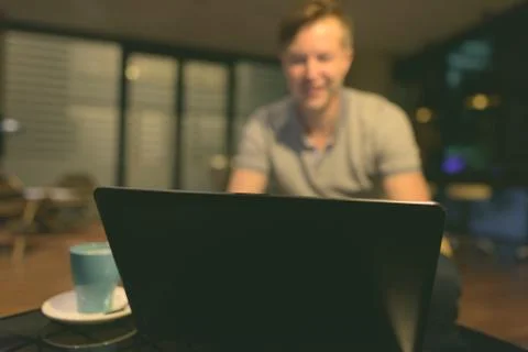 Young handsome man using laptop in the living room Fotos de archivo