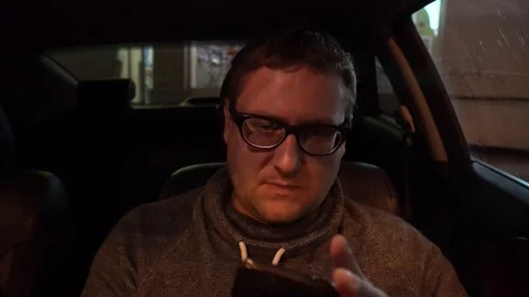 Young handsome man using mobile phone in the car Stock Footage 89319697