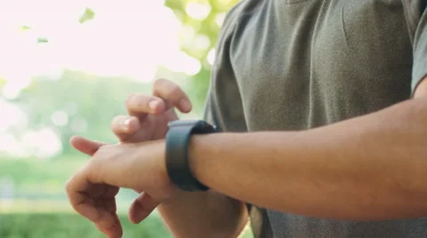 Young Handsome Man using Smart Watch during Morning Run in Park 動画素材 68434500