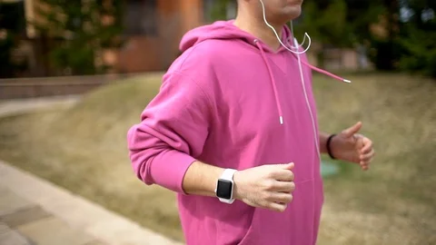 Young Handsome Man using Smart Watch during Morning Run in Park. Stock Footage 89406287