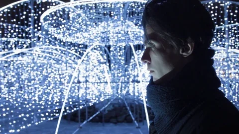 Young handsome man using smartphone standing alone outdoors at night city park Stock Footage 83631910