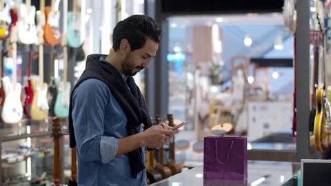 Young handsome man using smartphone and payment by smartphone contactless Stock Footage 120437268