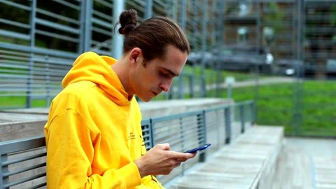 Young handsome man using smartphone mobile on sports area chatting with friends 스톡 동영상 135674937