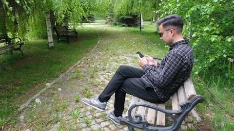 Young handsome man using smartphone outdoor Stock-Footage 279942384