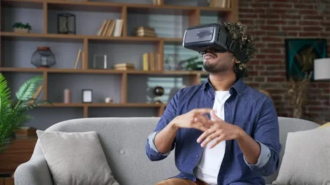Young handsome man using VR glasses for video call and chatting in virtual real 스톡 동영상 334230724