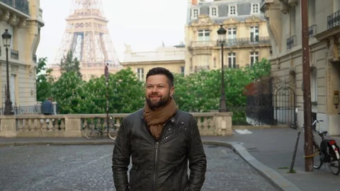 Young handsome man is walking down the street in Paris Stock Footage 108637537