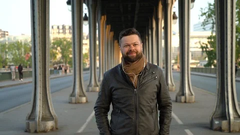 Young handsome man is walking down the street in Paris Stock Footage 108637558