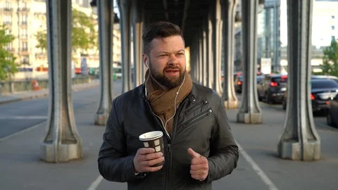 Young handsome man is walking down the street in Paris Stock Footage 108637559