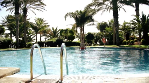 Young handsome man walking out of the pool  Stock Footage 1059660