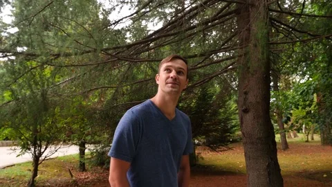 Young handsome man walking in the woods, enjoying nature, 4k close-up, slow Stock Footage 80413884