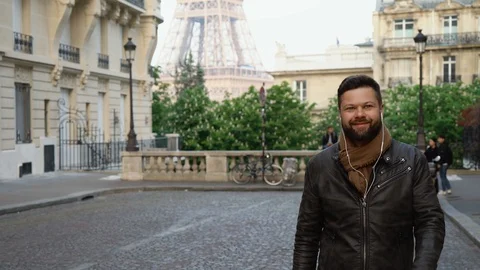 Young handsome man walks down the street in Paris Stock Footage 108689006