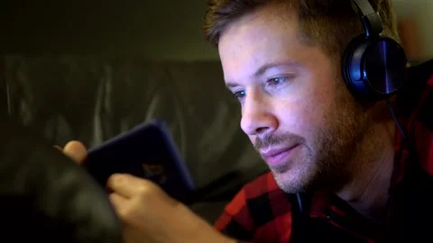 Young Handsome Man Watching A Streaming Online Video On Mobile Phone Stock Footage 139858424