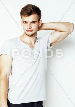 Young handsome man on white background gesturing, pointing, posing emotional Stock Photos