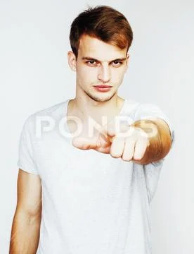 Young handsome man on white background gesturing, pointing, posi Stock Photos