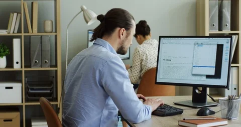 Young handsome man working on the computer at his office and it being broken Stock-Footage 91602584