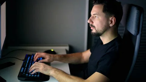 Young handsome man working on a computer at night gets a sad, shocking news. Stock Footage 169107334