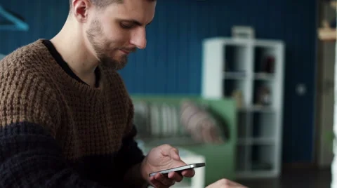 Young handsome man working on smart phone in coffee shop Stock Footage 62656465