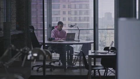 A young, handsome man works in an office space. Stock Footage