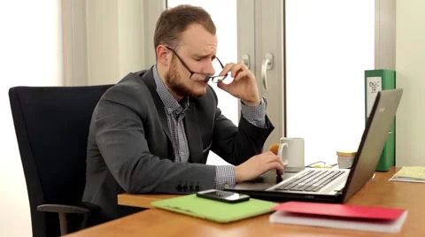 Young, handsome men sitting behind the desk. Stock Footage 49339886