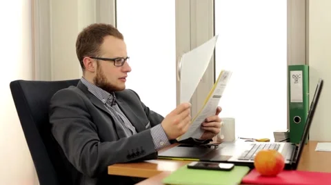 Young, handsome men sitting behind the desk Stock Footage 49340839