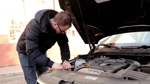 Young, handsome men standing behind his car and looking into engine. (2) Stock Footage 49338016