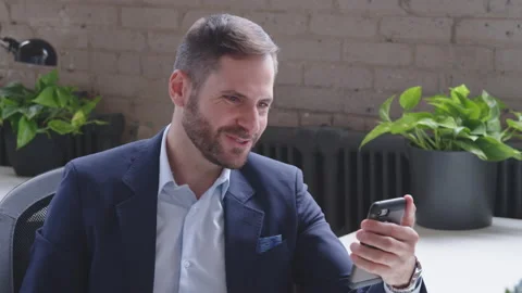 A young, handsome middle-eastern man is making a video call to relatives and Stock Footage 136543803