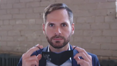 A young handsome middle-eastern man putting on surgical mask for corona virus Stock Footage 136545739