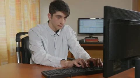 Young handsome programmer having an outsourcing helping hand typing Stock Footage 58958454