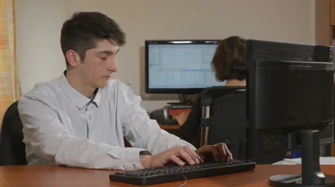 Young handsome programmer throwing paper balls into his co-worker Stock Footage 58959687