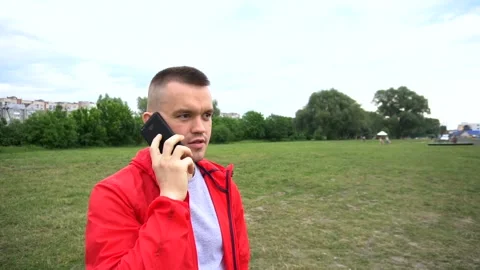 Young handsome runner in red hook wear talking on cellphone Stock Footage 90844463