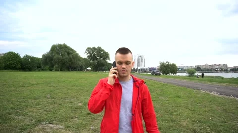 Young handsome runner in red hook wear talking on cellphone Stock Footage 90845026