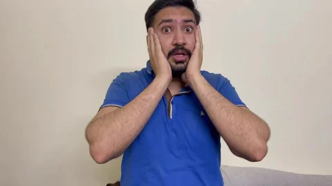 Young handsome surprised guy isolated over white background after hearing a bad  Stock Footage 241446478