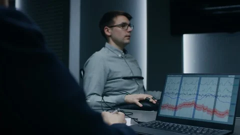 Young Handsome Suspect During Interrogation Undergoes Lie Detector / Polygraph Stock Footage 94570438
